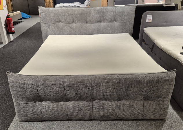 Boxspringbett „Kasper“, grauer Bezug, 7-Zonen-Taschenfederkern, 180 x 200 cm, im Möbelausstellungsraum ausgestellt.
