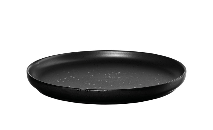 Der Brotteller Coppa 21 cm von ASA Selection ist ein runder, schwarzer Porzellanteller mit weißen Sprenkeln und einem erhöhten Rand.