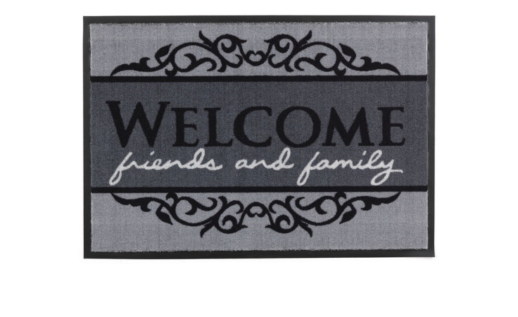 Die Astra Fußmatte Homelike 40 x 60 cm ist eine grau-schwarze Fußmatte aus Nylon mit dem Text "WELCOME friends and family".