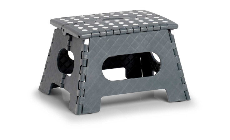 Der Klapphocker 35 x 28 x 22 cm ist ein kleiner grauer Klapphocker mit weißen Tupfen auf weißem Grund.