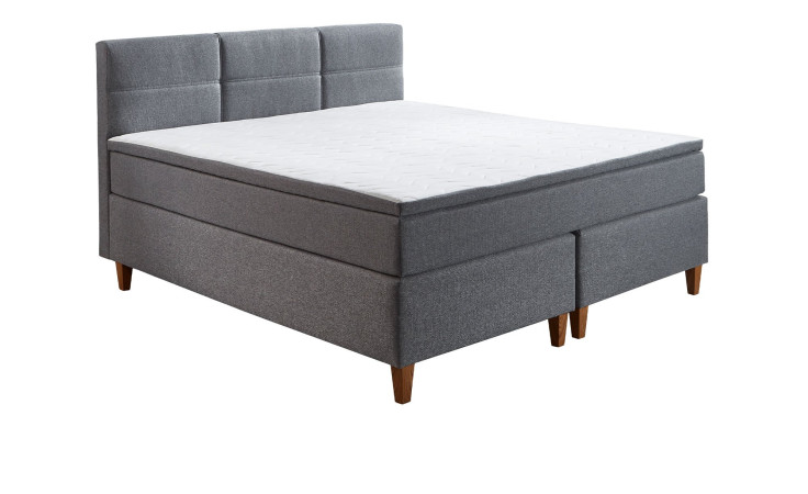 Boxspringbett Kansas in Grau mit einem Mikrofaserbezug und Füße in Eichen-Look..