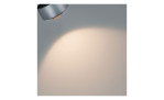 Der LED-Schienenspot URail 17 cm in silberfarben metallic wirft weiches Licht auf eine schlichte, helle Wand.