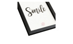 Pro-Art Rahmenbild Smile 24 x 19 cm: Schwarzer Rahmen, "Smile" kursiv auf weiß, kleines rosa Muschelmuster.