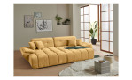 Wohnlandschaft Poppy in Beige mit ausziehbarer Sitztiefenverstellung und Ottomane links im hellen Raum mit Holzfußboden.