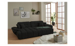 Wohnlandschaft Poppy in Schwarz mit ausziehbarer Sitztiefenverstellung und Ottomane links im hellen Raum mit Holzfußboden.