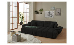 Wohnlandschaft Poppy in Schwarz mit Relaxfunktion und Ottomane rechts im hellen Raum mit Holzfußboden.
