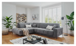 Wohnlandschaft Luan in Grau mit Cord-Optik, inszeniert auf gemustertem Teppich mit schwarzem Couchtisch und Stehlampe.