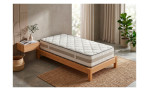 Minimalistisches Schlafzimmer mit Federkernmatratze „Easydream TFK 5320“, Topfpflanzen, einem gewebten Teppich und einem schwebenden Nachttisch.